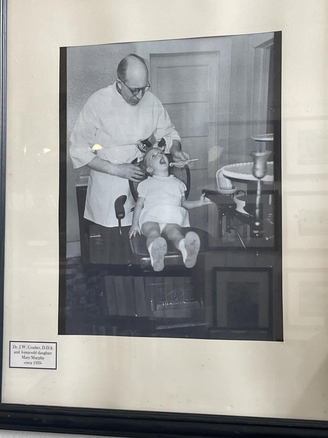 Original museum photograph of a historic dentist and child